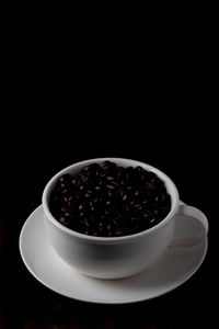 Coffee cup against black background