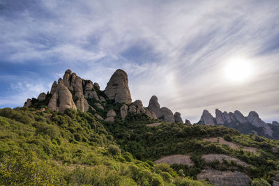 Low angle view of rock formation against sky