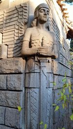 Low angle view of statue against building