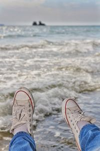 Man's feet on the beach, relaxing on the beach 