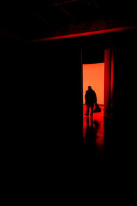 Silhouette man and woman walking in building