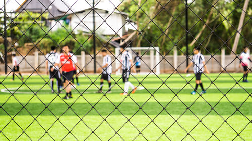 People playing soccer on field