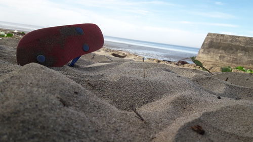 Close-up of beach against sky