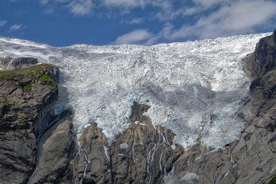 Low angle view of briksdalsbreen glacier against sky