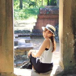 Portrait of smiling young woman sitting outdoors