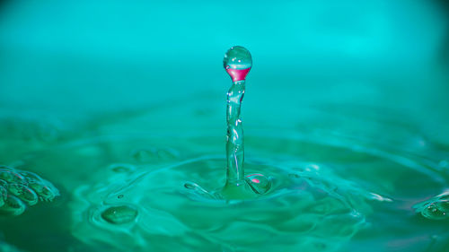 Close-up of drop falling in water