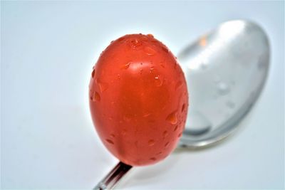 Close-up of apple on glass against white background