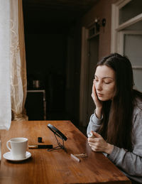 Young woman using mobile phone at home