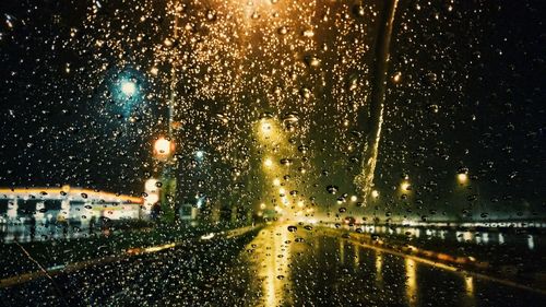 Raindrops on road seen through wet window