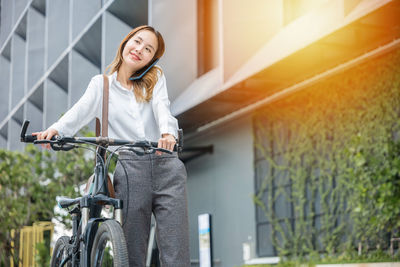 Portrait of young woman riding bicycle