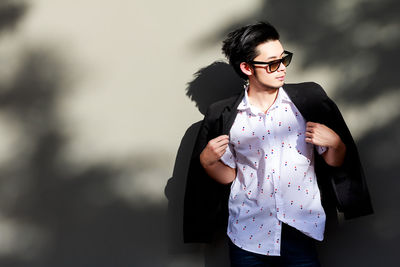 Young woman wearing sunglasses standing outdoors