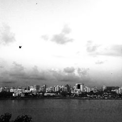 Scenic view of harbor against sky in city