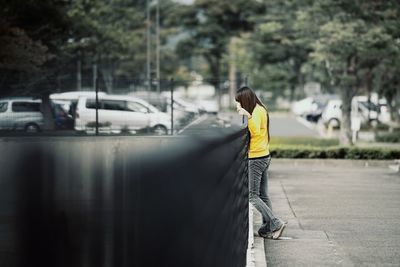 Rear view of man standing on road