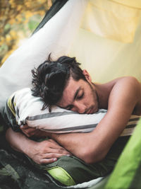 Midsection of man sleeping on bed