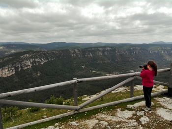 Scenic view of mountains against cloudy sky