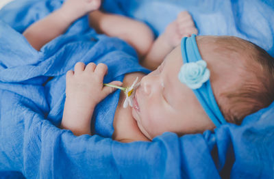 Cute baby with flower sleeping in crib
