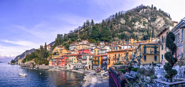 Buildings by town against sky