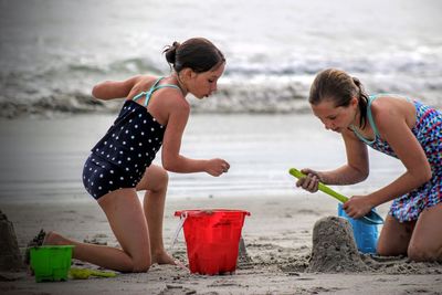 Girls building sandcastle