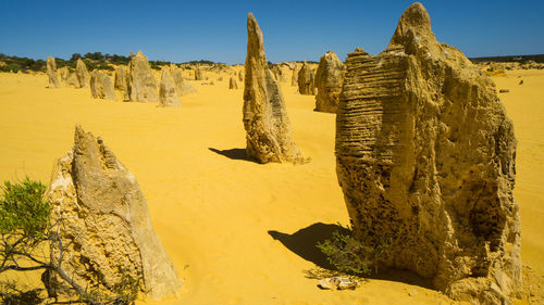 Panoramic view of rocks on desert against sky