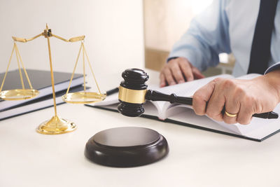 Close-up of man holding camera on table