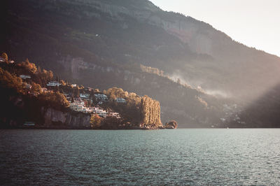 Scenic view of sea by mountains