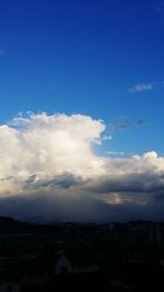 Cityscape against cloudy sky