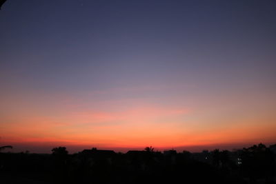 Silhouette landscape against sky at sunset
