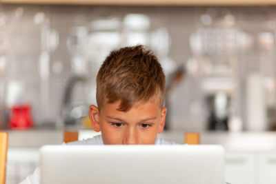 Portrait of boy using mobile phone