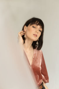 Young woman looking away against white background