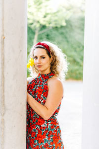 Portrait of young woman standing outdoors