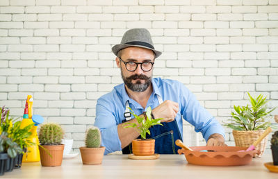 Portrait of man with potted plants