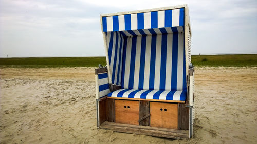 Lifeguard hut on beach against sky