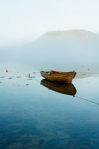 Fishing boat in sea against sky