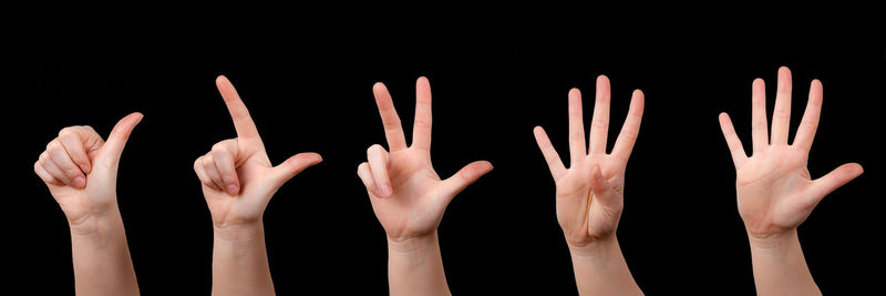 Close-up of hand against black background