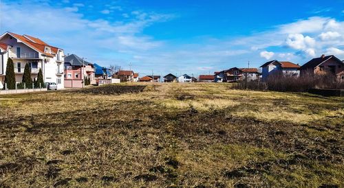 Houses on field against sky