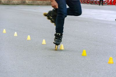 Low section of man skating on road