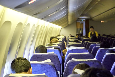 Rear view of airhostess in airplane