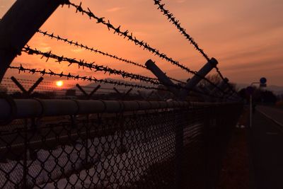 Sunset seen through chainlink fence