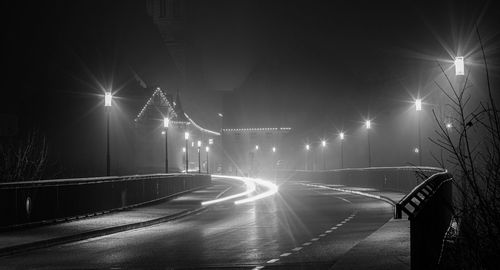 Light trails on road in city at night