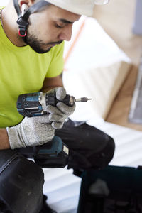 Male worker using drill