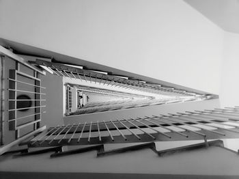 Low angle view of piano on table against building