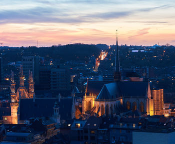 High angle view of illuminated buildings against sky at sunset