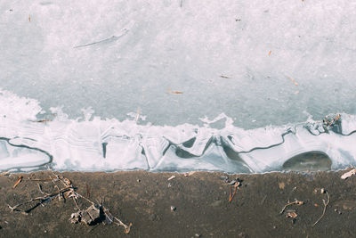 High angle view of frozen sea shore