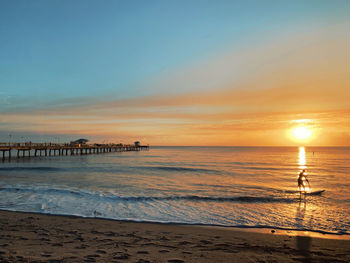 Scenic view of beach against sky during sunset