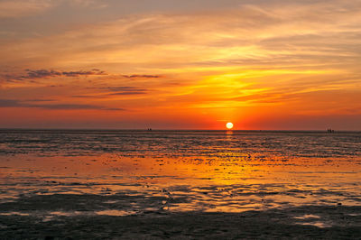 Scenic view of sea against romantic sky at sunset