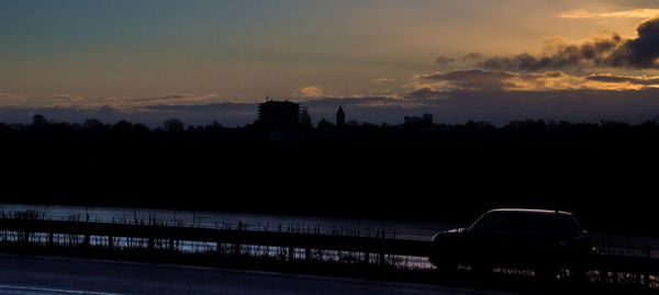 Silhouette bridge against sky during sunset