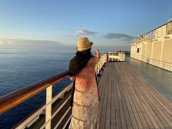 Rear view of woman looking at sea against sky