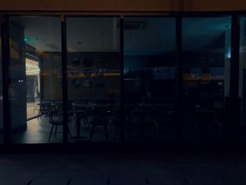 Empty chairs and table in restaurant at night