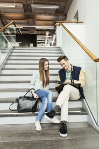 Friends sitting on steps in university