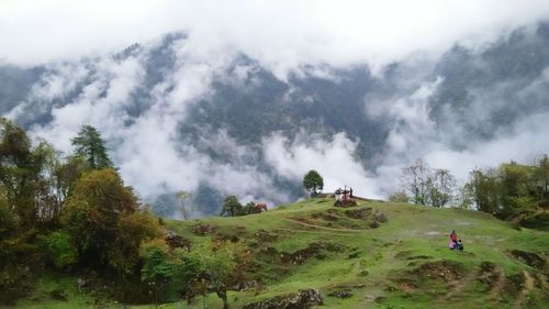 Panoramic view of people on landscape against sky